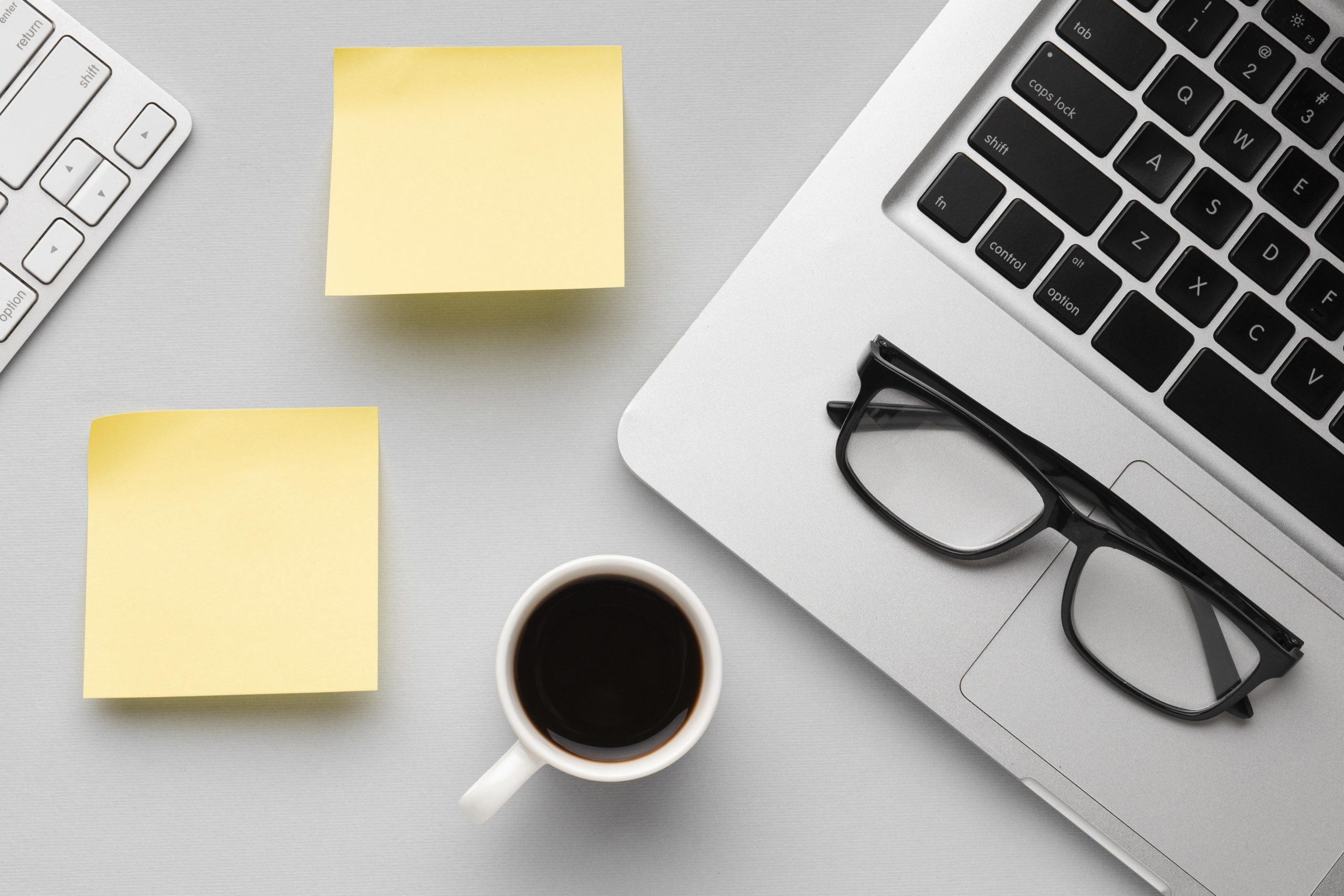 top-view-office-desk-composition-with-empty-post-its